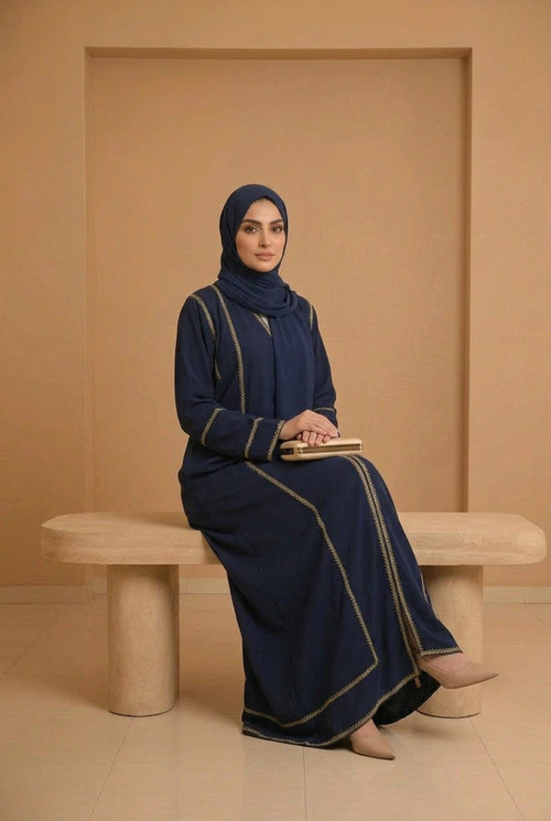 Abaya Nefertiti bleu marine à broderies dorées, portée sur mannequin, vue de face