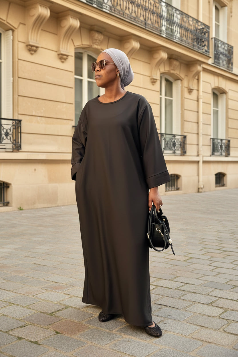Abaya Mina noire – vue de face, portée dans une rue parisienne